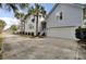 Long driveway leading to the garage, surrounded by lush landscaping and a charming neighborhood street at 2516 Willbrook Ln, Mount Pleasant, SC 29466