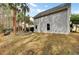 Exterior view showcasing the siding, windows, and grassy backyard with palm trees at 2516 Willbrook Ln, Mount Pleasant, SC 29466