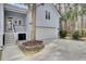 Attached garage with a white door, adjacent to a staircase, and a well-maintained driveway at 2516 Willbrook Ln, Mount Pleasant, SC 29466