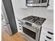 Close-up of stainless steel range and fridge in the kitchen with white marble countertops at 2516 Willbrook Ln, Mount Pleasant, SC 29466