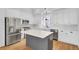 Bright kitchen featuring stainless steel appliances, white cabinets, and a center island with a marble countertop at 2516 Willbrook Ln, Mount Pleasant, SC 29466