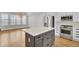 Kitchen with stainless steel appliances, white cabinets, and a center island with a marble countertop at 2516 Willbrook Ln, Mount Pleasant, SC 29466