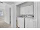 Bright laundry room features white cabinets, modern washer, and dryer at 2516 Willbrook Ln, Mount Pleasant, SC 29466
