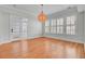 Bright living room with french doors, hardwood floors, and modern light fixture at 2516 Willbrook Ln, Mount Pleasant, SC 29466