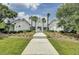 Inviting pool entrance with palm trees and well-manicured landscaping leading to the community pool area at 2516 Willbrook Ln, Mount Pleasant, SC 29466