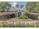 RiverTowne on the Wando Swim and Tennis Center entrance framed by colorful flowers and lush landscaping at 2516 Willbrook Ln, Mount Pleasant, SC 29466