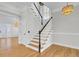 Stylish staircase with wood treads and white risers, complemented by a unique light fixture at 2516 Willbrook Ln, Mount Pleasant, SC 29466