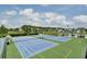 Community tennis courts and pond with clear blue sky in this outdoor park, a place for sports and relaxation at 2516 Willbrook Ln, Mount Pleasant, SC 29466