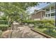 Charming brick-paved walkway lined with mature trees, lush landscaping, and inviting park benches at 2516 Willbrook Ln, Mount Pleasant, SC 29466