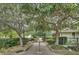 Charming community brick walkway with lush landscaping, mature trees, and community seating at 2516 Willbrook Ln, Mount Pleasant, SC 29466