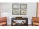 Sitting area features neutral wall color, unique wall art, an accent table and leather chairs at 300 Blue Haw Dr, Moncks Corner, SC 29461