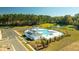 Aerial view of a community pool and lake surrounded by trees and landscaping at 301 Blue Haw Dr, Moncks Corner, SC 29461