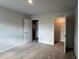 Bedroom with neutral carpet and walls, featuring a closet and doorway at 301 Blue Haw Dr, Moncks Corner, SC 29461