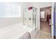 Bathroom featuring a soaking tub, a glass shower and access to the main bedroom at 322 Freeland Way, Moncks Corner, SC 29461