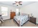 Bedroom features a ceiling fan, a dresser, a nightstand, and natural light at 322 Freeland Way, Moncks Corner, SC 29461