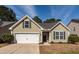 Charming single-story home with green siding, attached garage and well-maintained lawn at 322 Freeland Way, Moncks Corner, SC 29461