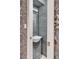 View of a modern powder room with designer wallpaper and a decorative mirror at 330 Concord St # 14 A, Charleston, SC 29401