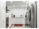 Compact galley kitchen with stainless steel appliances and white cabinets at 330 Concord St # 14 A, Charleston, SC 29401