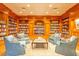 Cozy library with wooden bookshelves, trim, and comfortable blue armchairs at 330 Concord St # 14 A, Charleston, SC 29401