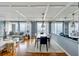 Open-concept living and dining area with water views, wood floors and a large mirror at 330 Concord St # 14 A, Charleston, SC 29401