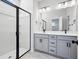 Bathroom featuring double vanity, white marble floors, and tiled walk-in shower at 365 Chapman Cir, Goose Creek, SC 29445
