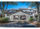 Exterior view of a multi-story home with a two-car carport and mature trees at 401 Yacht Harbor Ct, Isle of Palms, SC 29451