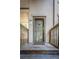 Inviting front door with glass panel, wooden steps, and decorative pineapple accent at 401 Yacht Harbor Ct, Isle of Palms, SC 29451