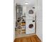 Laundry room featuring a stacked washer and dryer unit, a storage rack, and a utility sink at 401 Yacht Harbor Ct, Isle of Palms, SC 29451