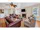 Cozy living room with a fireplace, comfortable seating, and a ceiling fan at 401 Yacht Harbor Ct, Isle of Palms, SC 29451