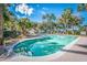 Community pool with lounge chairs, palm trees, and a clear blue sky, perfect for relaxation at 401 Yacht Harbor Ct, Isle of Palms, SC 29451
