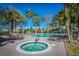 A luxurious pool area with a hot tub, lounge chairs, and shade trees offers relaxation and resort-style living at 401 Yacht Harbor Ct, Isle of Palms, SC 29451
