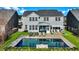 Aerial view of backyard with swimming pool, patio, lounge chairs, screened-in porch, and pergola at 402 Spectrum Rd, Summerville, SC 29486