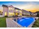 Spacious backyard with a stunning pool, brick patio, and a covered seating area perfect for entertaining at 402 Spectrum Rd, Summerville, SC 29486