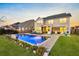 Expansive backyard featuring a pristine pool, brick patio, and a covered patio with outdoor seating at 402 Spectrum Rd, Summerville, SC 29486