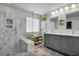 Bathroom with a glass shower, gray vanity, double sinks and wood look floors at 402 Spectrum Rd, Summerville, SC 29486