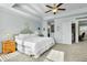 Bedroom with soft blue walls, neutral carpet, tray ceiling and access to laundry room at 402 Spectrum Rd, Summerville, SC 29486