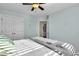 Comfortable bedroom with a ceiling fan, white closet doors, and neutral colored walls at 402 Spectrum Rd, Summerville, SC 29486