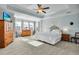 Spacious bedroom features tray ceilings, neutral walls and floors, and a comfy bed at 402 Spectrum Rd, Summerville, SC 29486
