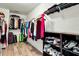 Walk-in closet with shelving, hanging racks, and wood-look flooring at 402 Spectrum Rd, Summerville, SC 29486