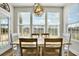 Sunlit dining area featuring a chandelier, natural light, and a rustic table set for a cozy meal at 402 Spectrum Rd, Summerville, SC 29486