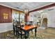 Charming dining area with a rustic table, comfortable seating, and views of the home's staircase at 402 Spectrum Rd, Summerville, SC 29486