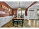 Formal dining area featuring a rustic table, elegant chairs, and natural light from the window at 402 Spectrum Rd, Summerville, SC 29486