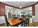 Inviting dining space with a rustic table, six chairs, and open view to the living room and stairs at 402 Spectrum Rd, Summerville, SC 29486
