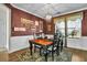 A well-lit dining room features a rustic wooden table, complemented by black chairs and a decorative rug at 402 Spectrum Rd, Summerville, SC 29486