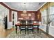 The dining room showcases a rustic wooden table, dark chairs, and a warm, inviting color scheme at 402 Spectrum Rd, Summerville, SC 29486