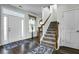 Welcoming foyer with hardwood floors, carpeted staircase, and ample natural light at 402 Spectrum Rd, Summerville, SC 29486
