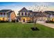 Charming two-story home featuring a well-manicured lawn and inviting front porch with white columns at 402 Spectrum Rd, Summerville, SC 29486