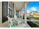 Inviting front porch with white rocking chairs and black shutters at 402 Spectrum Rd, Summerville, SC 29486