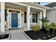Charming blue front door with black mulch landscaping and sidelight window at 402 Spectrum Rd, Summerville, SC 29486