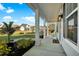 Bright and airy covered front porch with black shutters at 402 Spectrum Rd, Summerville, SC 29486